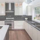 Kitchen With Black Countertops And White Cabinets