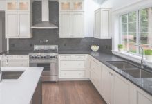 Kitchen With Black Countertops And White Cabinets